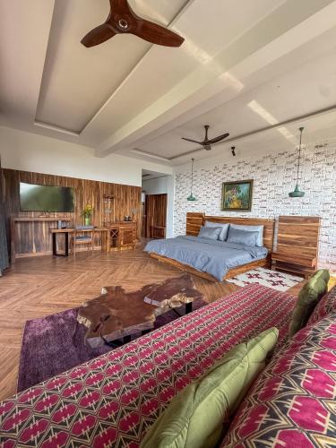 a bedroom with two beds and a ceiling fan at Mum Griham in Rewalsar