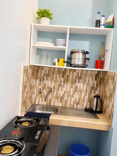 a kitchen with a stove and a counter top at Studio in kilifi close to beach and supermarket in Kilifi