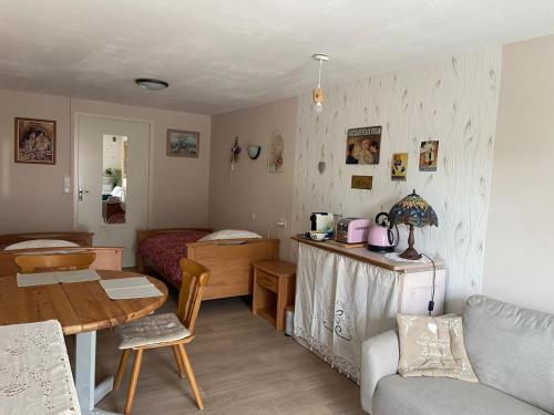 a small room with a table and a bed at Le temps d'une pause bed and breakfast in Servance