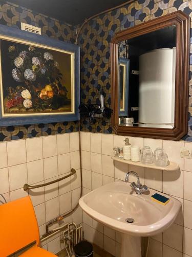 a bathroom with a sink and a mirror at Le temps d'une pause bed and breakfast in Servance