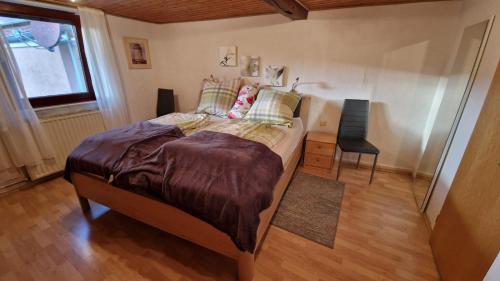 a bedroom with a bed and a table and a window at Ferienwohnung Altrichter 1 in Wabern