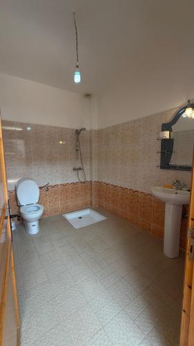 a bathroom with a toilet and a sink at Peaceful Retreat in Oulad Akkou