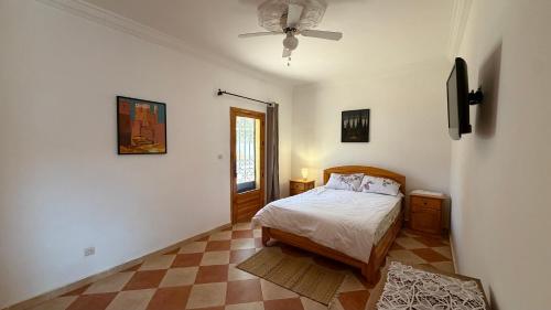 a bedroom with a bed and a ceiling fan at Peaceful Retreat in Oulad Akkou