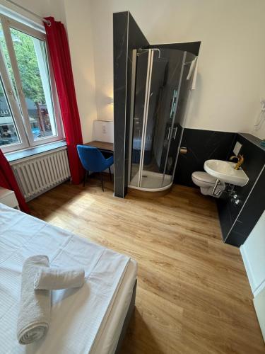 a bathroom with a large shower and a sink at Hotel Haus Schwan Köln in Cologne