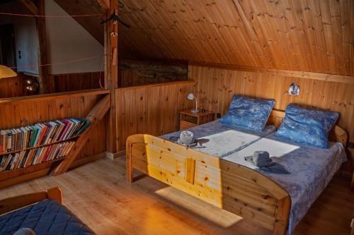 a bedroom with a bed in a wooden room at Chata Ujo in Hranice