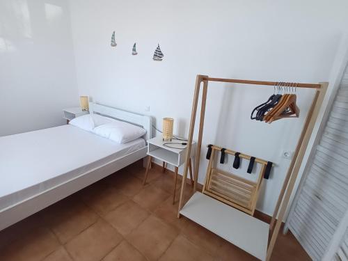 a small bedroom with a bed and a mirror at Evdokia3 in Koufonisia