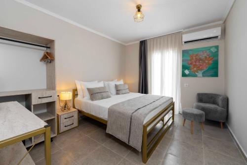 a bedroom with a bed and a desk and a chair at Porto Sol Hotel Bodrum in Bodrum City