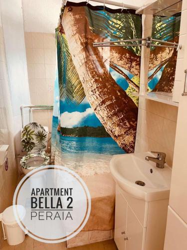a bathroom with a shower curtain that reads apartment bellaria peraja at Apartment Bella 2 Perea in Perea
