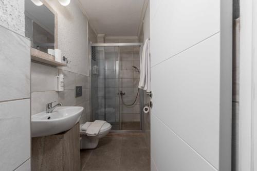 a bathroom with a sink and a toilet and a shower at Porto Sol Hotel Bodrum in Bodrum City