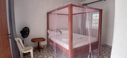 a bedroom with a bed with a glass wall at Ngalula Half London Resort in Dzitsuhe
