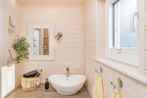 a bathroom with a sink and a window at Hausboot Sophie in Stralsund in Stralsund