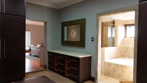 a bathroom with a tub and a sink and a shower at Myrtle Leaf Apartments in Springs