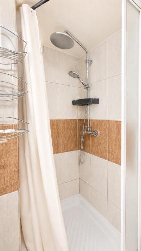 eine Dusche mit Duschvorhang im Badezimmer in der Unterkunft Plaz Hotel in Selianitika