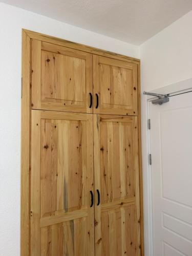 a closet with wooden cabinets in a room at Armeda Restoran ve Pansiyon in Datca