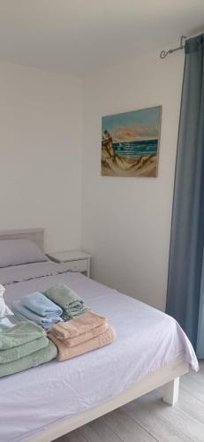 a bedroom with a bed with towels on it at Apartman Vida in Zaton