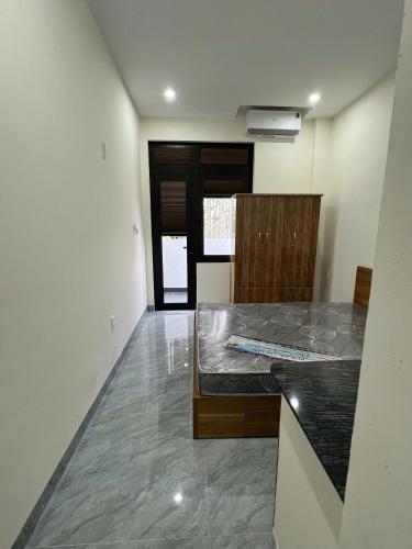 a room with a bed in the middle of a room at The F House in Danang