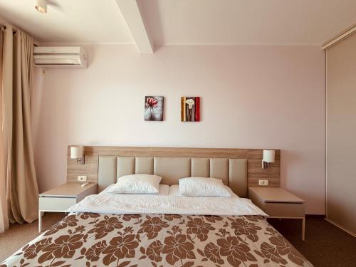 a bedroom with a large bed with two night stands at Tophill Altezza 9 Breathtaking Views and Terrace in Budva