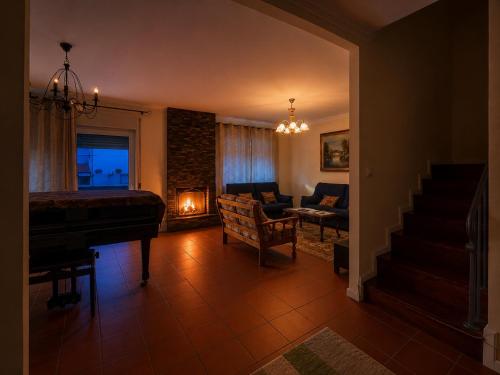 a living room with a piano and a couch at Spacious Villa near Porto - BBQ and Private Parking in Vila Nova de Gaia