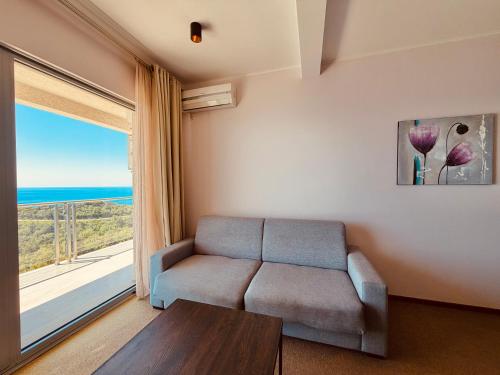 a living room with a couch and a large window at Tophill Altezza 9 Breathtaking Views and Terrace in Budva