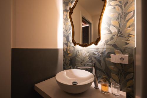 a bathroom with a sink and a mirror at J&B Imola Home in Imola