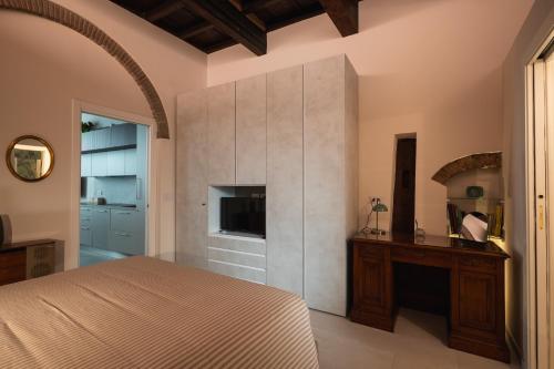 a bedroom with a large bed and a fireplace at J&B Imola Home in Imola
