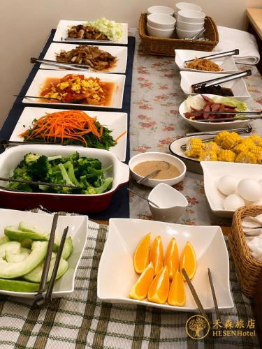 a table with many plates of food on it at He Sen B&B in Kenting