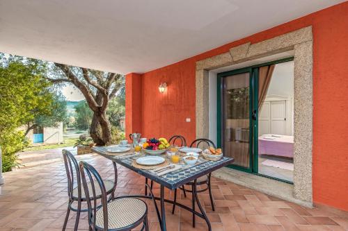 a patio with a table and chairs on a patio at Domos Pintadas -Happy Rentals in Rudalza