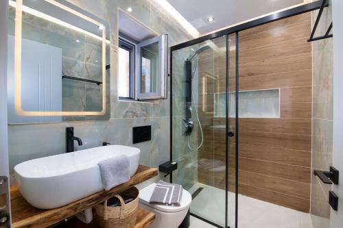 a bathroom with a sink and a shower at TS Luxury villa in Velianitátika