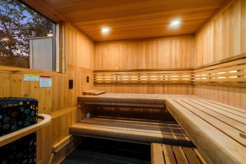 an empty sauna with wooden walls and a window at Art & Soul Main House in Lyndhurst