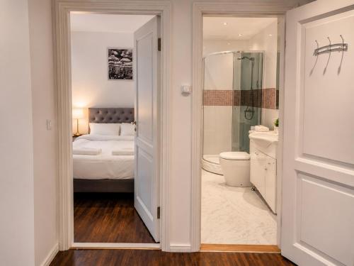 a bathroom with a bedroom with a bed and a toilet at Tallinn Residence 1937 in Tallinn