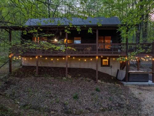 a house with a deck with lights on it at Bear Tracks Cottage in Nellysford