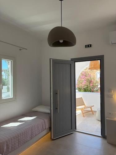 a bedroom with a bed and a sliding glass door at The Dream in Ios Chora