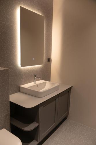 a bathroom with a sink and a mirror at Apart-hotel Pahulja in Jahorina