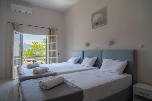 a bedroom with two beds with towels on them at Irida Studios and Suite in Paleokastritsa