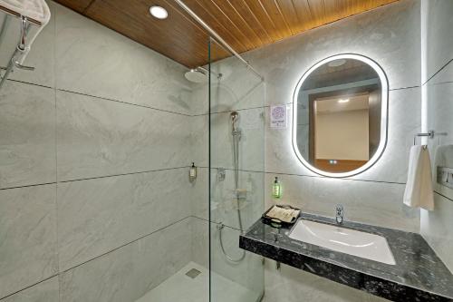 a bathroom with a sink and a mirror at Click Collection Aster, Raja Park - Jaipur in Jaipur