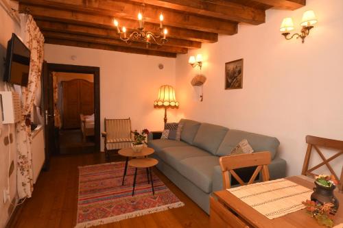 a living room with a blue couch and a table at Casa Lörinczi in Sighişoara