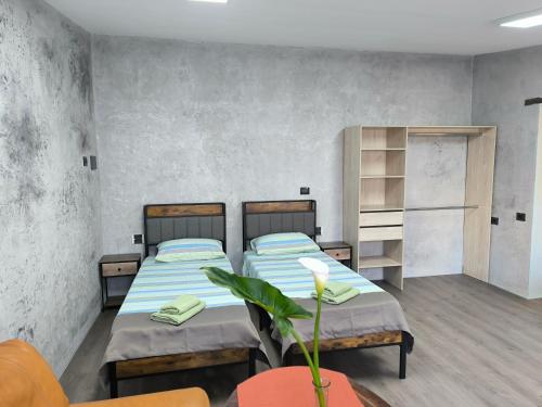 a room with two beds and a table and chairs at Villa Topaz in Capoterra