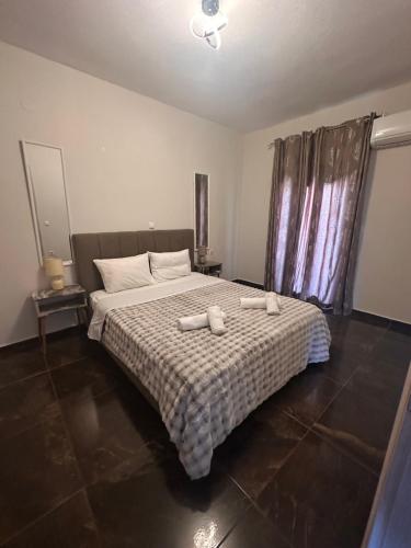 a bedroom with a bed with two towels on it at Natalie’s House in Alexandroupoli