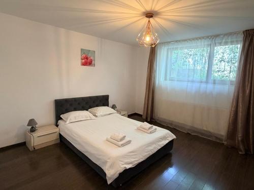 a bedroom with a bed with two towels on it at InnTime in Cluj-Napoca