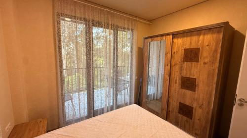 a bedroom with a bed and a large window at Sun Estate Ureki in Ureki