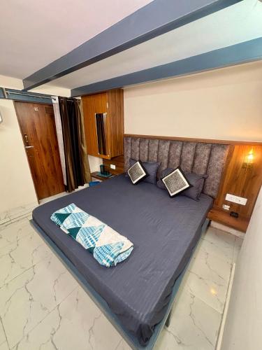 a bedroom with a bed with two pillows on it at Nirvana Homestay in Mathura