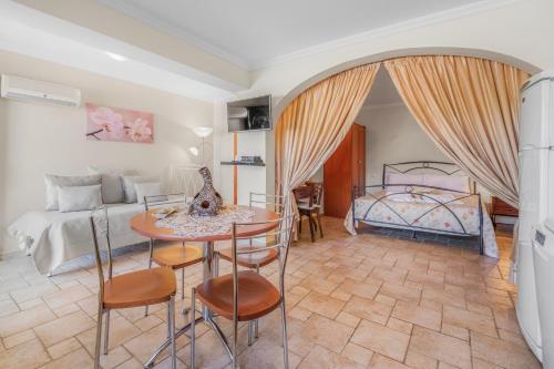 a living room with a bed and a table and chairs at Archontiko Loukis in Pentátion