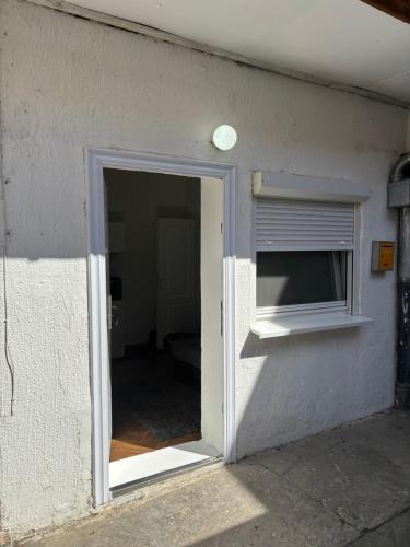 an open door to a room with a window at Novosadska Tvrdjava Apartments in Petrovaradin