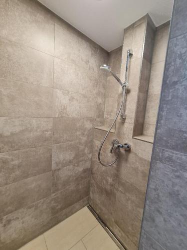 a shower with a glass door in a bathroom at Campingpark Rammingen in Rammingen