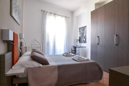 a bedroom with a large bed and a window at La Casa di Birba in Acquedolci
