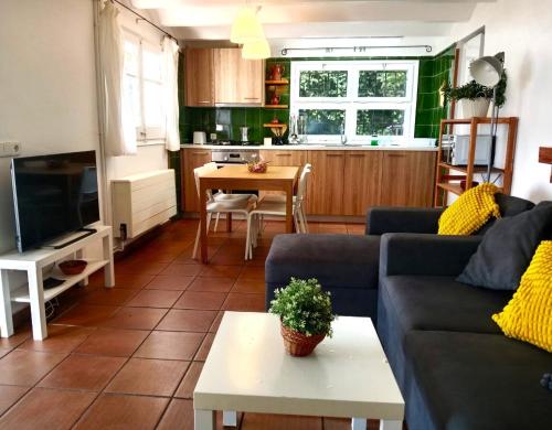 a living room with a couch and a table at Casa Flor de Taronger in Viladecáns