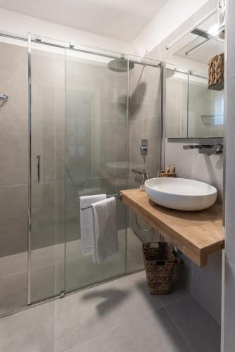 a bathroom with a sink and a glass shower at 360 view of the Sassi in Matera