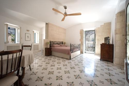 a bedroom with a bed and a ceiling fan at 360 view of the Sassi in Matera