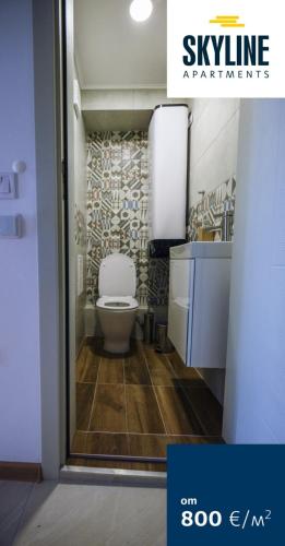 a bathroom with a white toilet and a sink at Skyline Apartments - Sea View, Pools, SPA&Free Parking in Varna City