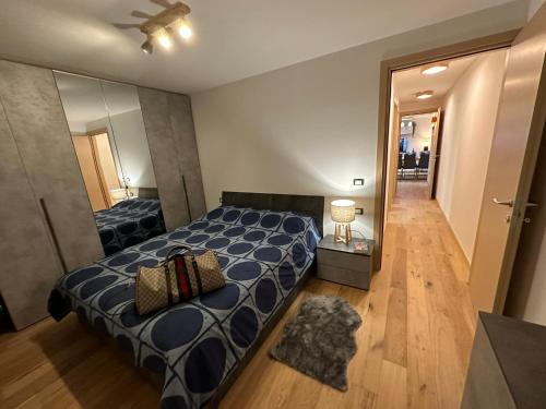 a bedroom with a bed and a mirror at SnowLodge Valmalenco in Caspoggio